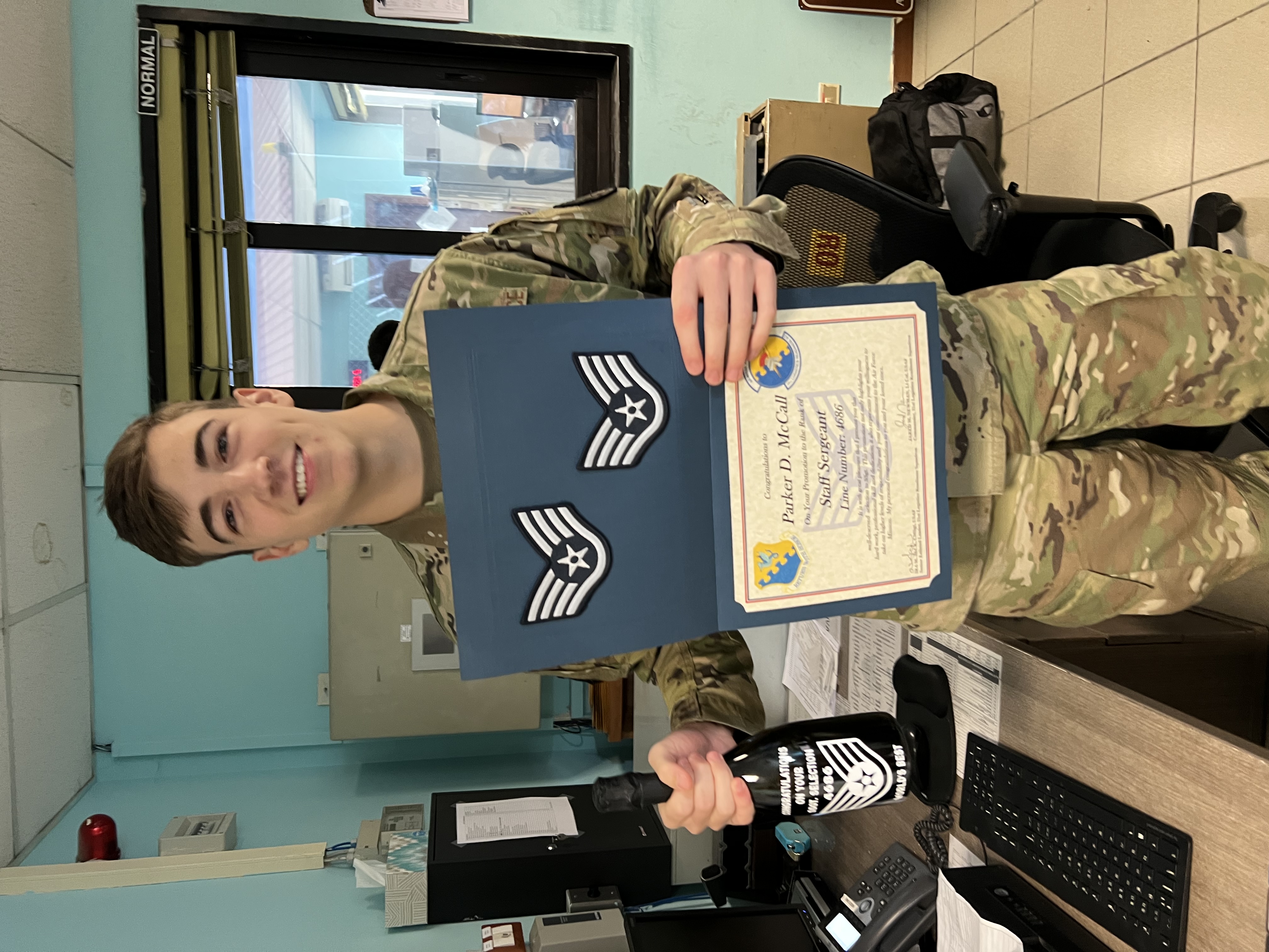 Parker McCall receiving Staff Sergeant promotion notification at Aviano Air Base, Italy